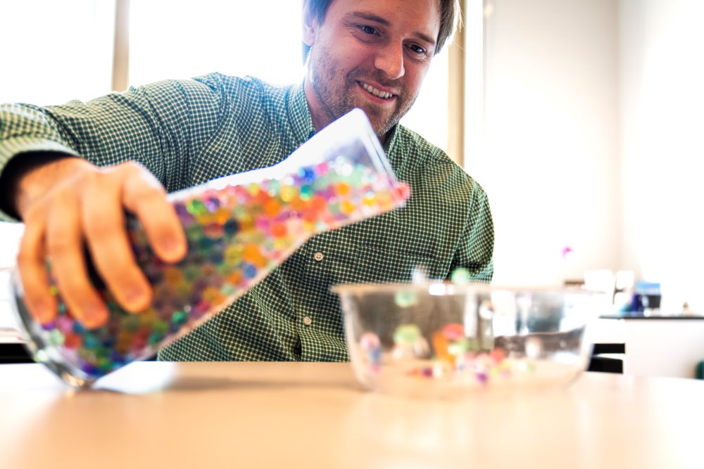 Assistant Professor Carl Goodrich and a toy model of amorphous solids.